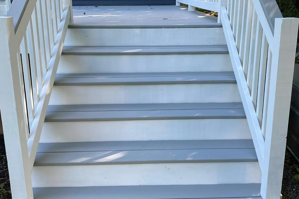 Deck stairs after: repaired and painted with white rails
