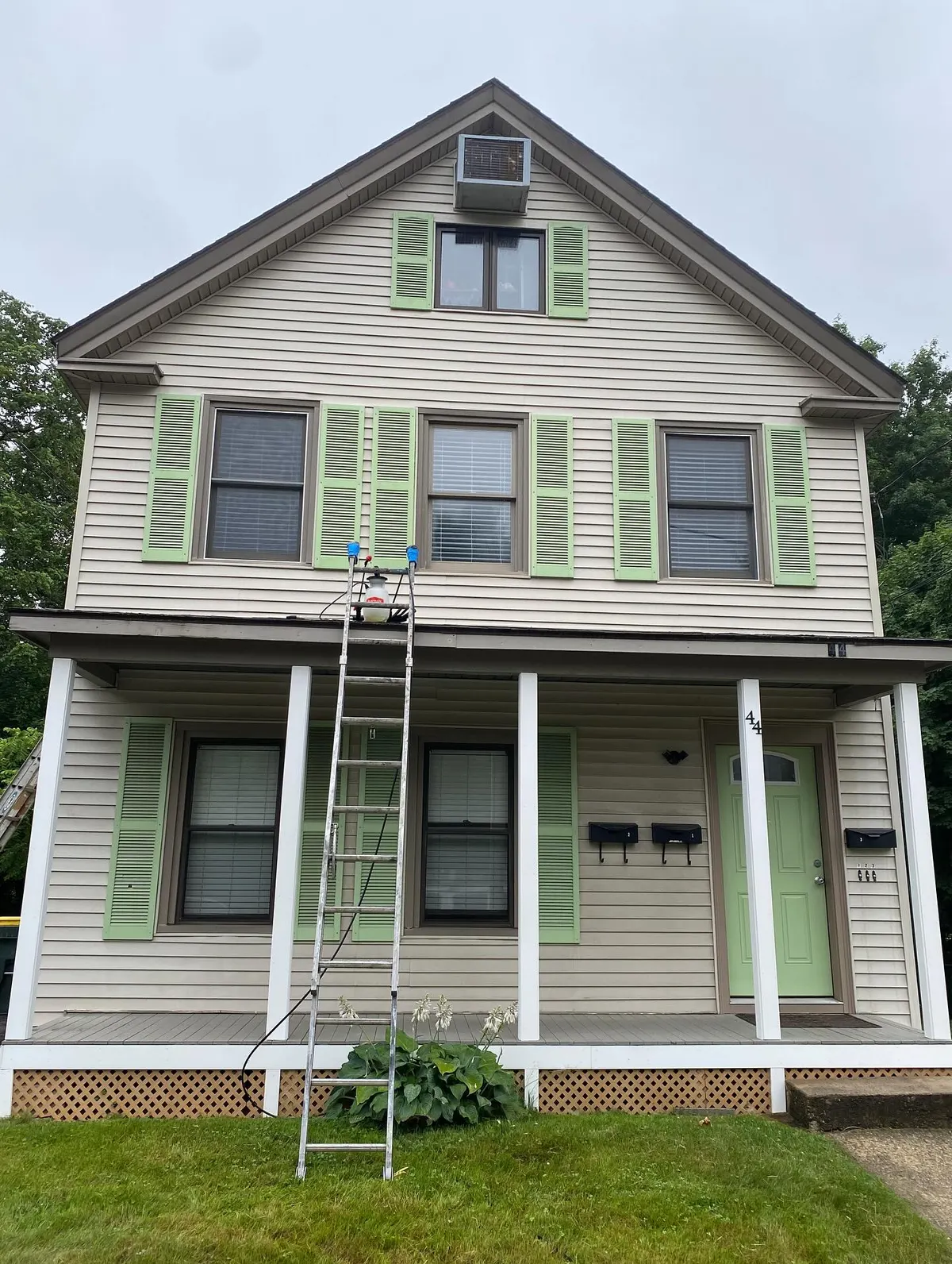 Two-story house with green shutters in Franklin