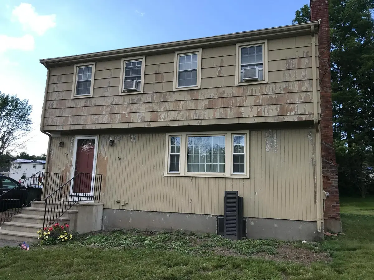 Two-story house with fresh paint and a red front door