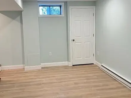 Finished basement with light walls and new floor