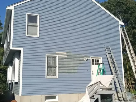 Blue siding being repainted