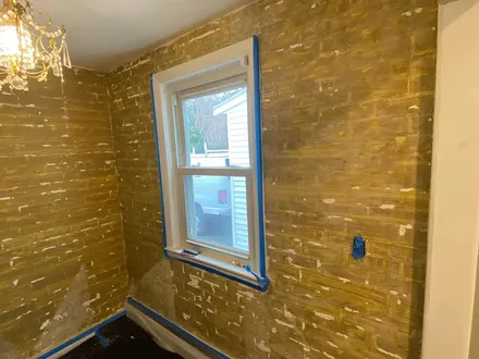 Room with wallpaper removed and walls being prepped